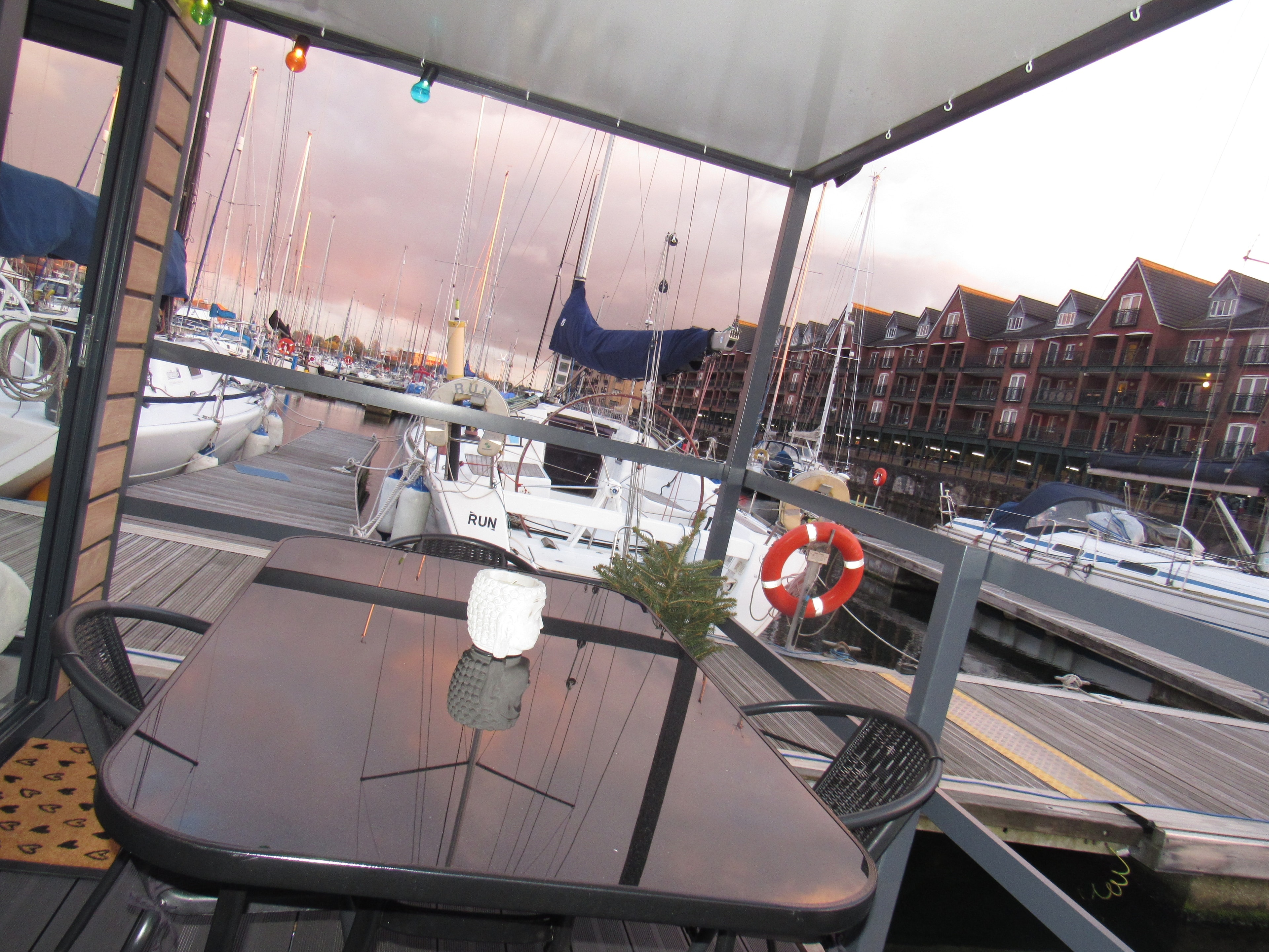Balcony with marina views and sailboats at sunset
