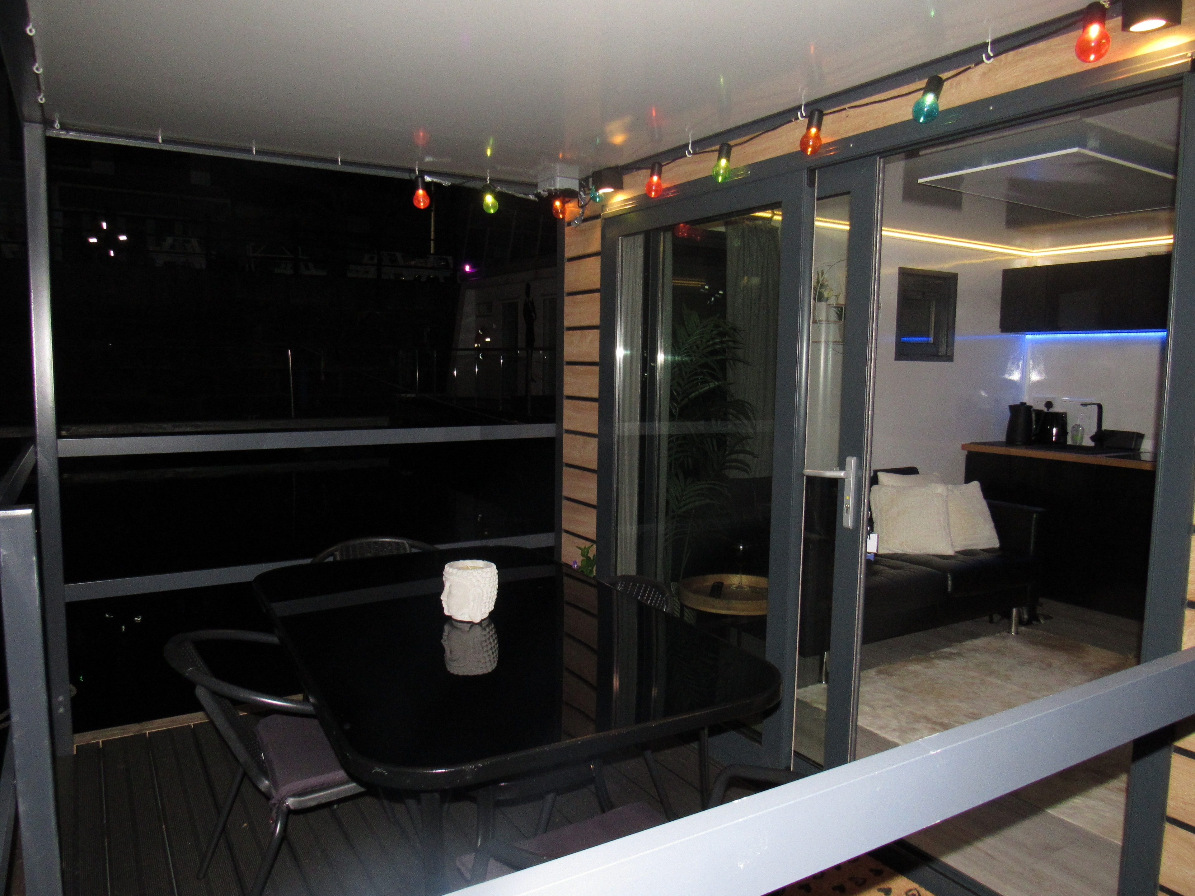 Balcony at night with colourful fairy lights
