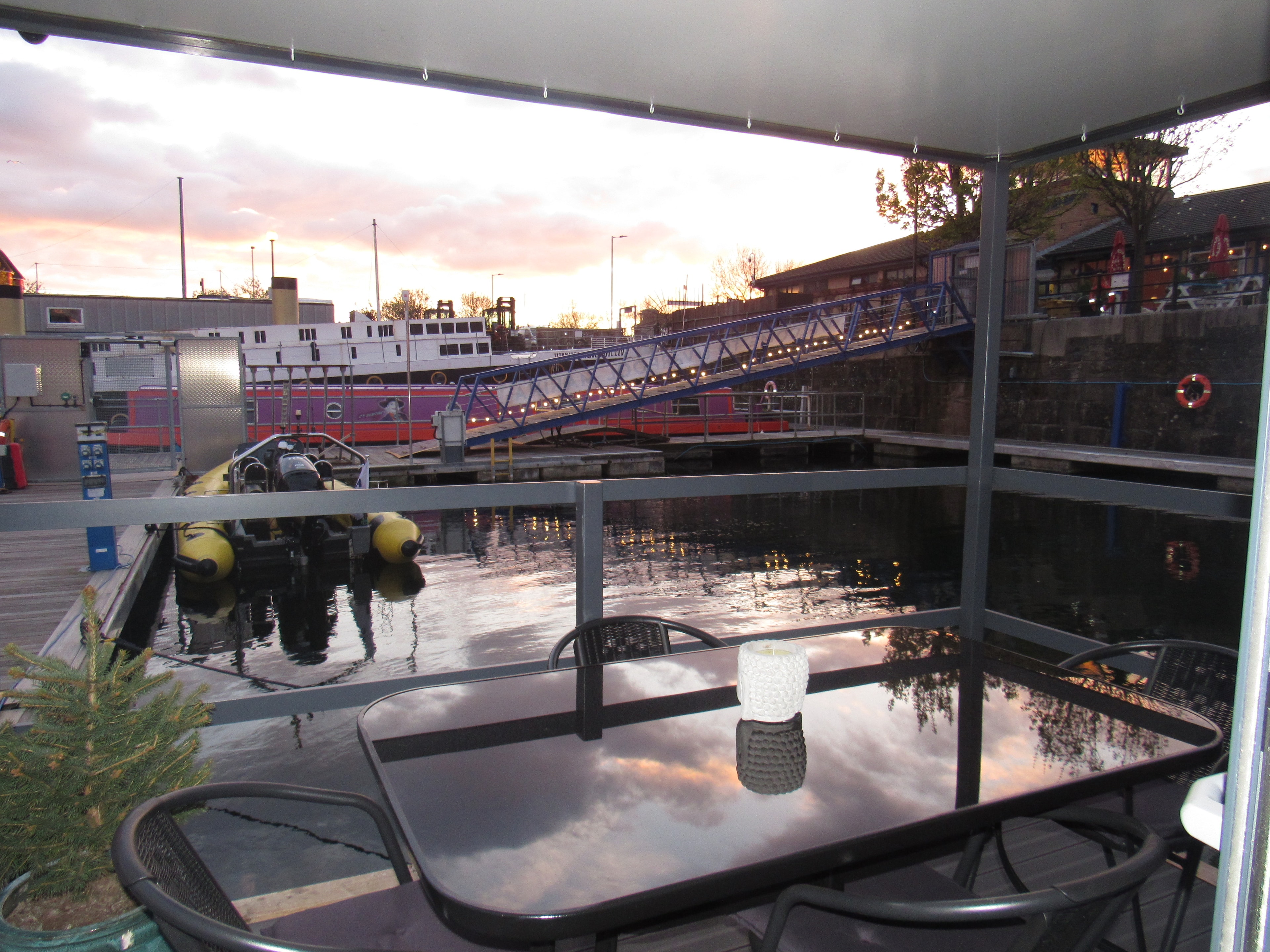 Balcony table at dusk overlooking the marina with the ferry bridge lit up